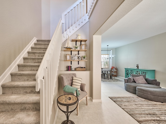 stairs featuring tile patterned flooring and a notable chandelier