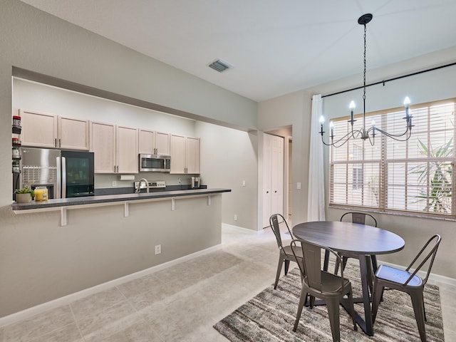 dining space featuring light tile patterned floors and an inviting chandelier