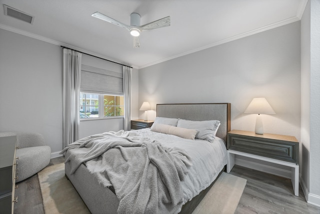 bedroom with ceiling fan, crown molding, and dark hardwood / wood-style floors