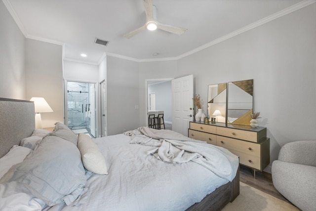 bedroom featuring hardwood / wood-style flooring, ensuite bath, ceiling fan, and ornamental molding