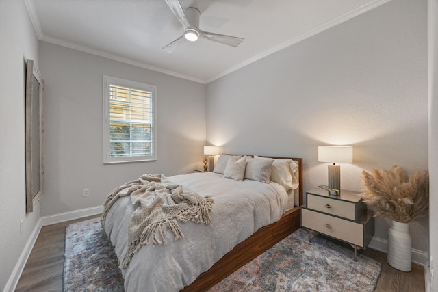 bedroom featuring dark hardwood / wood-style flooring, ceiling fan, and crown molding