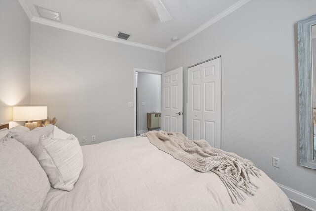 bedroom with hardwood / wood-style floors, ceiling fan, a closet, and crown molding