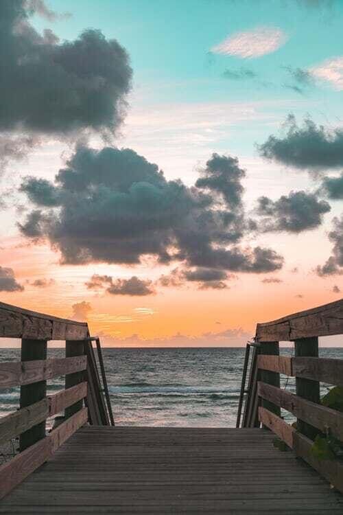 view of dock with a view of the beach and a water view