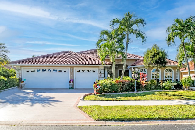 view of front facade with a garage and a front lawn