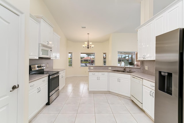 kitchen with white cabinetry, appliances with stainless steel finishes, sink, and decorative light fixtures