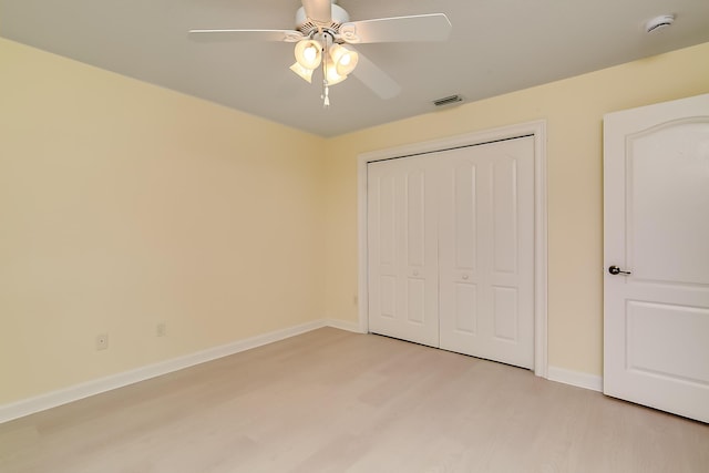 unfurnished bedroom with a closet, ceiling fan, and light wood-type flooring