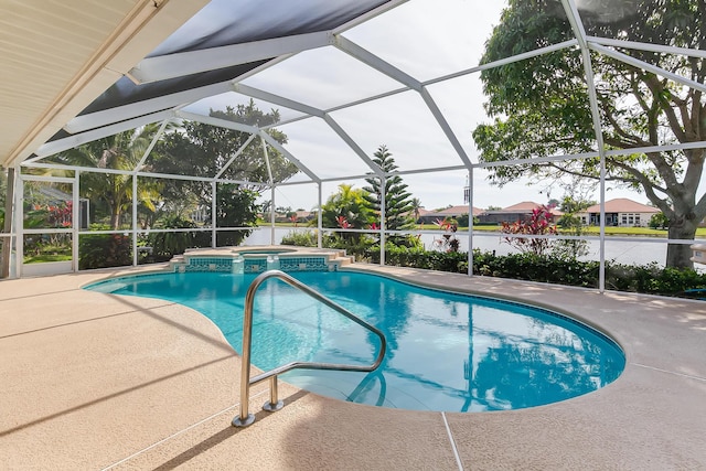 view of pool featuring an in ground hot tub, a water view, glass enclosure, and a patio area