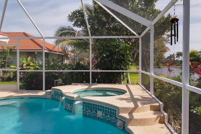 view of pool featuring an in ground hot tub, pool water feature, and glass enclosure