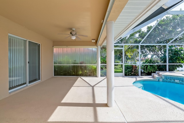 view of pool with a lanai, ceiling fan, and a patio area