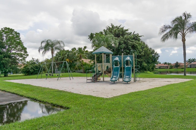 view of playground with a water view and a yard