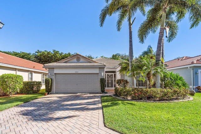 mediterranean / spanish-style house with a front lawn and a garage