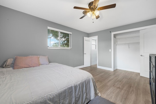 bedroom with a closet, ceiling fan, and hardwood / wood-style floors