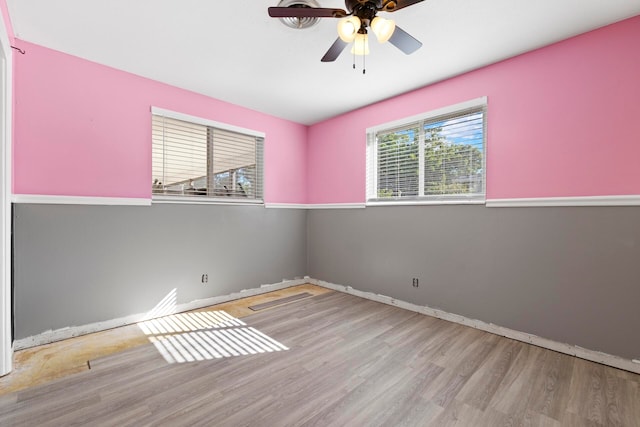 unfurnished room with ceiling fan and light wood-type flooring