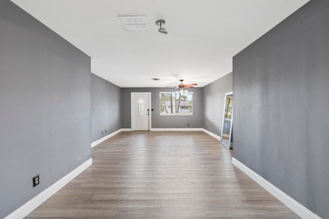 interior space with hardwood / wood-style flooring and ceiling fan