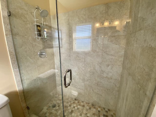 bathroom with toilet and walk in shower