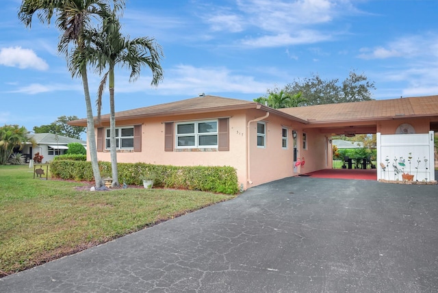 view of front of house with a front yard and a carport