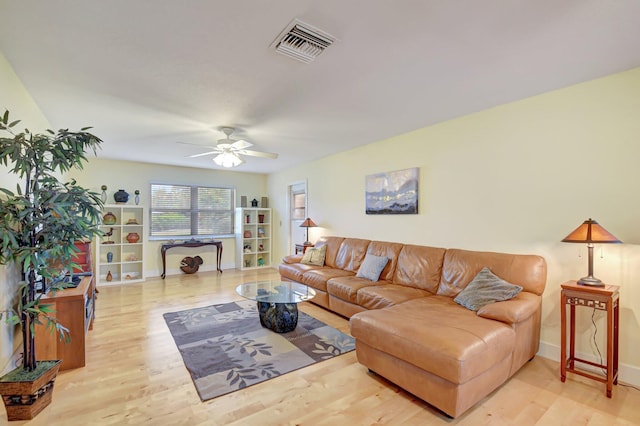 living room with ceiling fan and light wood-type flooring