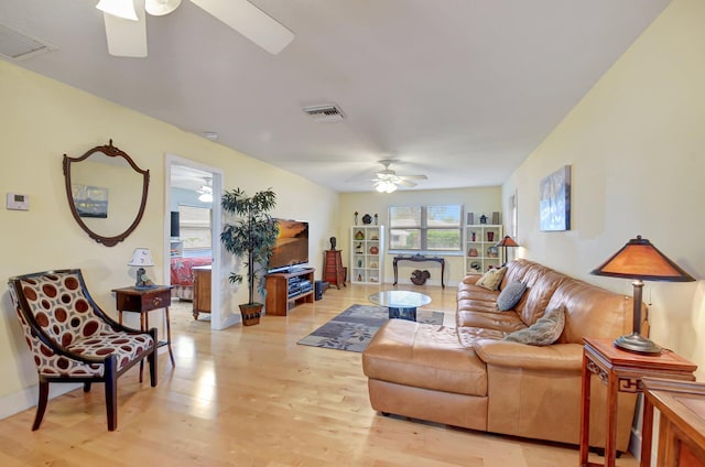 living room featuring ceiling fan and light hardwood / wood-style flooring