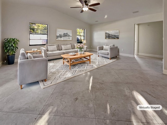 living room with a wealth of natural light, ceiling fan, and lofted ceiling