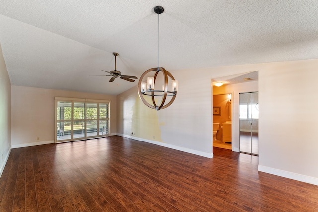 unfurnished room featuring a textured ceiling, ceiling fan with notable chandelier, dark hardwood / wood-style floors, and vaulted ceiling