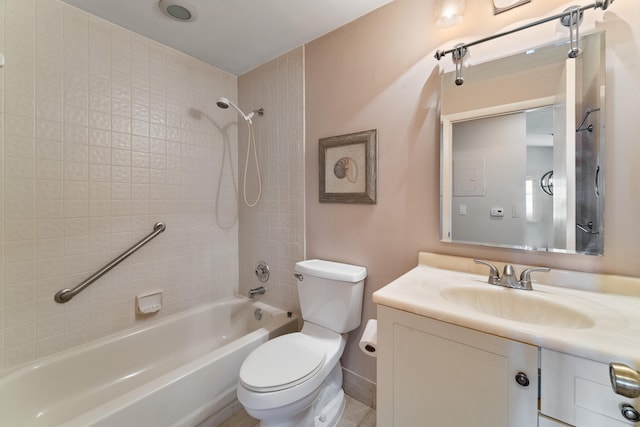 full bathroom featuring vanity, tiled shower / bath combo, and toilet