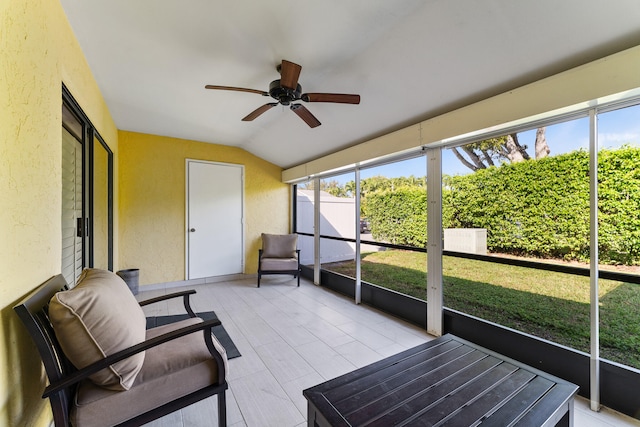 sunroom featuring ceiling fan and lofted ceiling