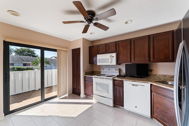 kitchen with light stone counters, dark brown cabinets, ceiling fan, and white appliances