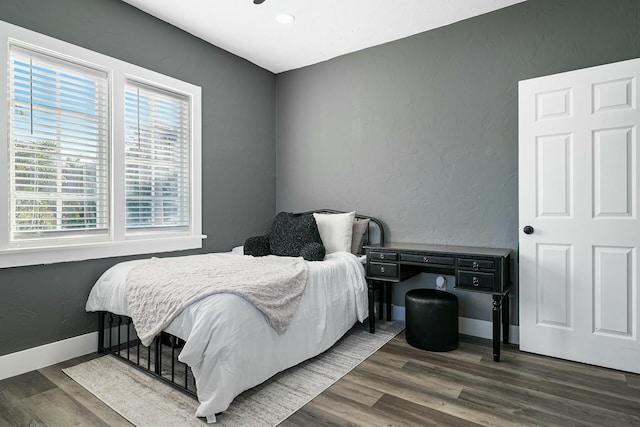 bedroom with dark hardwood / wood-style floors