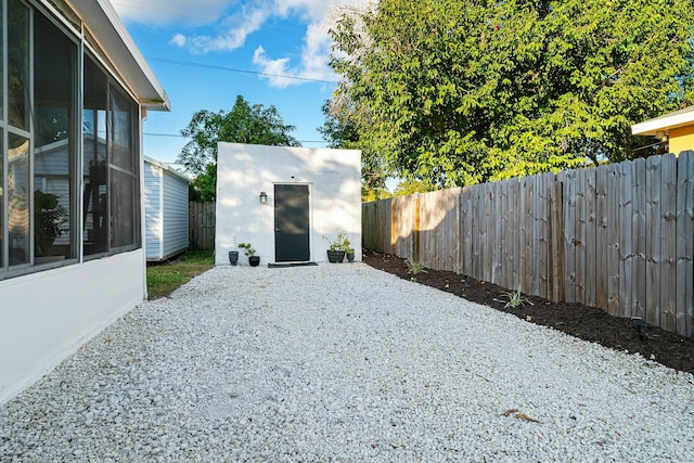 view of yard featuring a patio and an outdoor structure