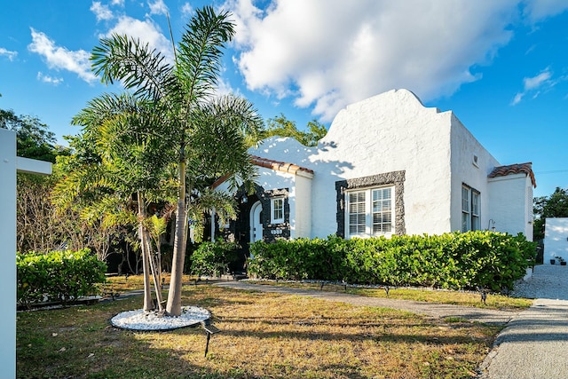 mediterranean / spanish-style house featuring a front lawn