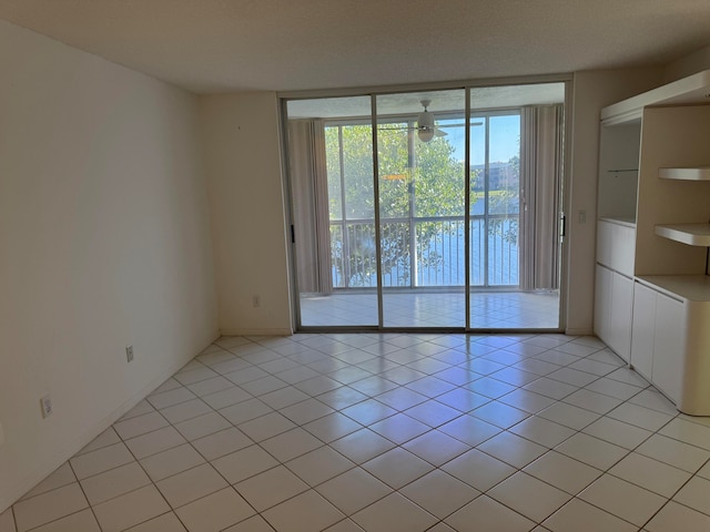 unfurnished room featuring light tile patterned floors