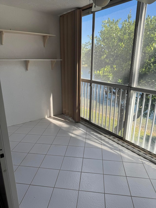 unfurnished sunroom featuring a water view and a wealth of natural light