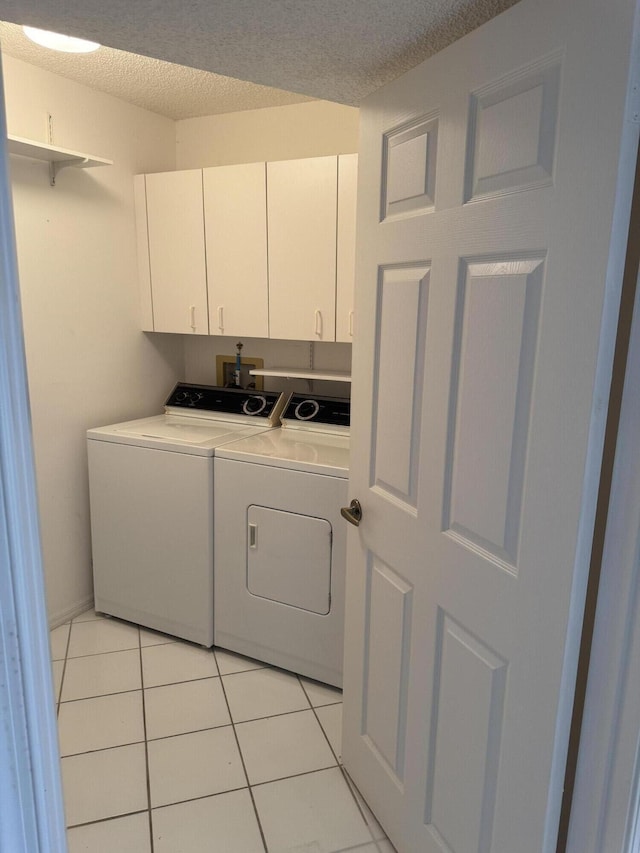 7516 N Devon Dr Unit 212, Tamarac, FL 33321 - washroom featuring cabinet space, washer and dryer, a textured ceiling, and light tile patterned floors