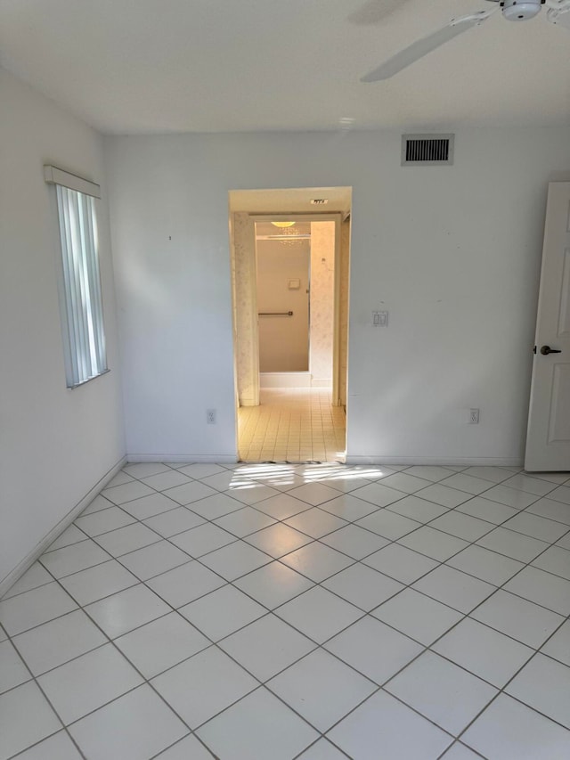 unfurnished room featuring light tile patterned floors and ceiling fan