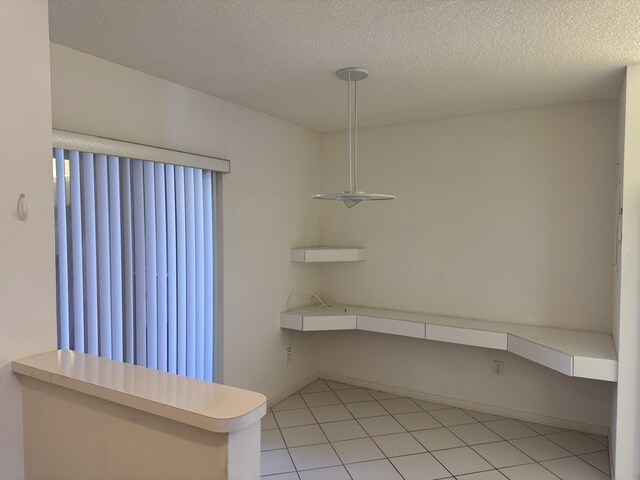 7516 N Devon Dr Unit 212, Tamarac, FL 33321 - unfurnished dining area with a textured ceiling and light tile patterned flooring