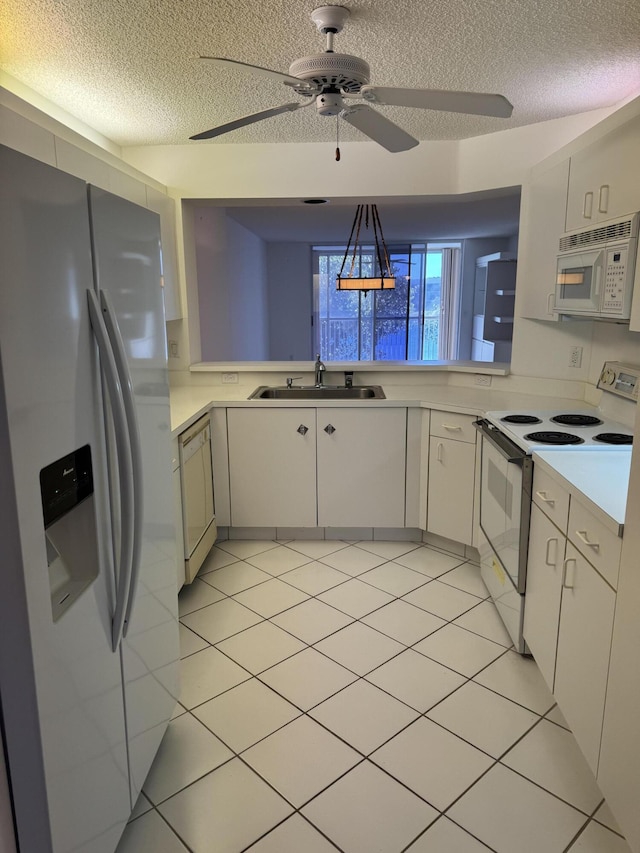 7516 N Devon Dr Unit 212, Tamarac, FL 33321 - kitchen featuring white appliances, a sink, a textured ceiling, a ceiling fan, and light countertops