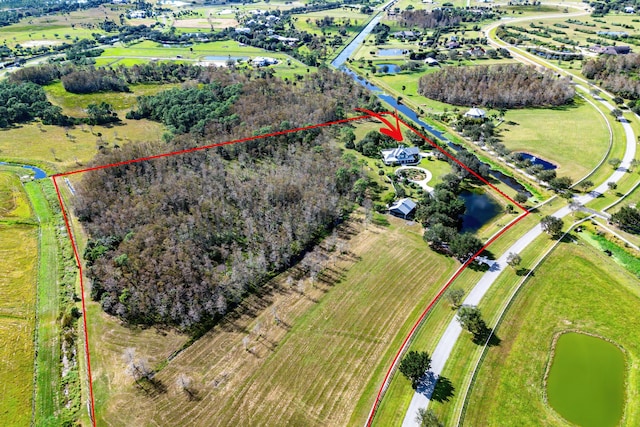 birds eye view of property with a rural view and a water view