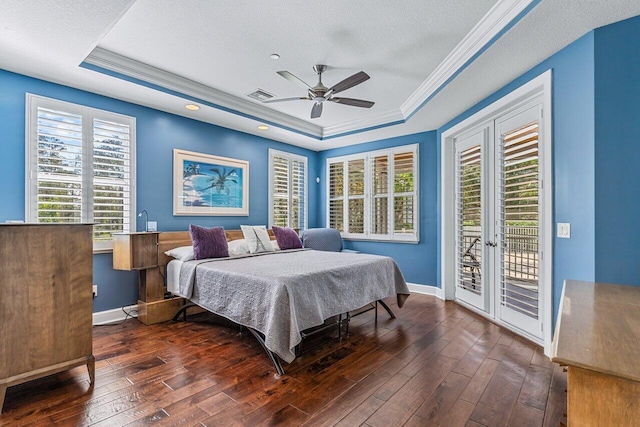 bedroom featuring access to exterior, ceiling fan, a raised ceiling, and dark wood-type flooring