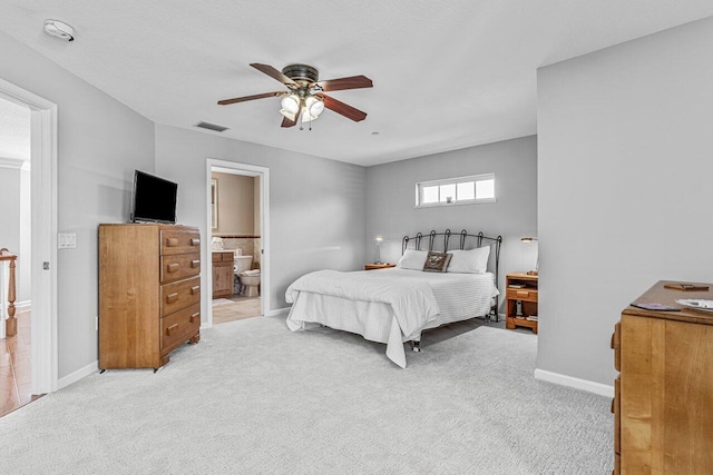 carpeted bedroom featuring ensuite bathroom and ceiling fan