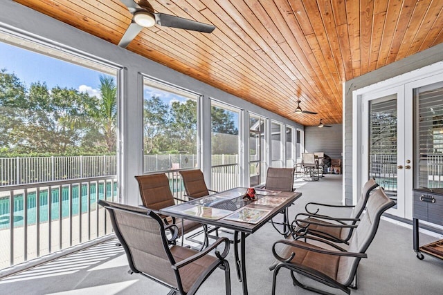 sunroom with ceiling fan, french doors, and wood ceiling