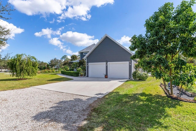 view of side of home with a garage and a yard