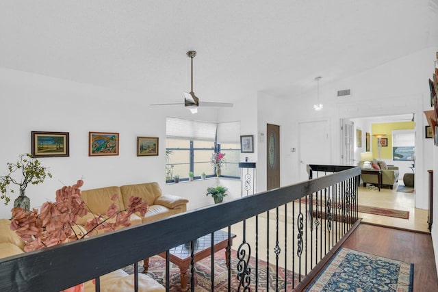 hall featuring wood-type flooring and vaulted ceiling