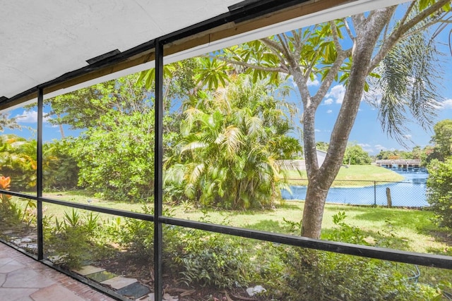 unfurnished sunroom with a water view