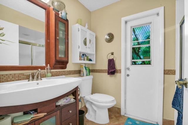 bathroom featuring walk in shower, tile patterned flooring, a textured ceiling, toilet, and vanity