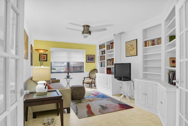 living area with built in features and ceiling fan