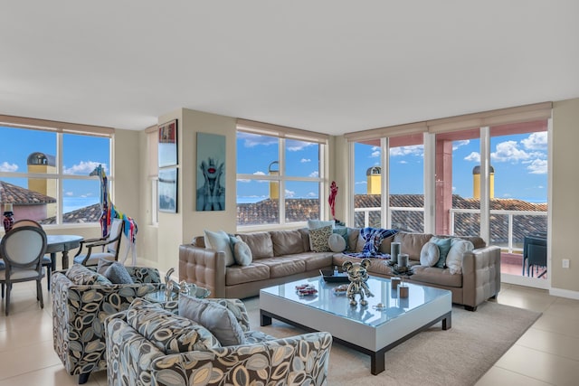 tiled living room with a wall of windows and a healthy amount of sunlight