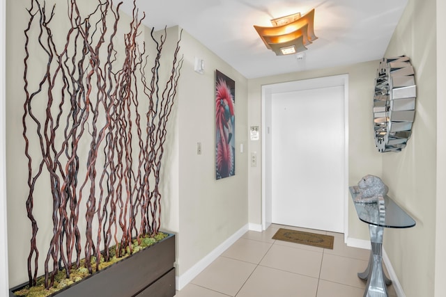 doorway to outside with light tile patterned flooring