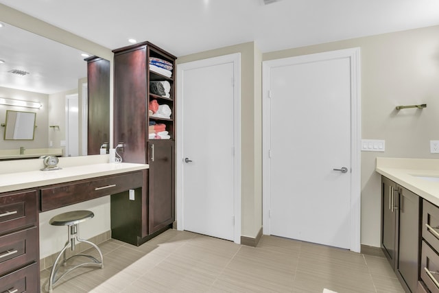 bathroom with tile patterned flooring and vanity