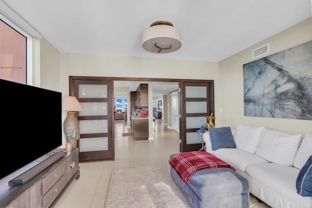 living room featuring plenty of natural light and light tile patterned flooring