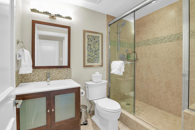 bathroom featuring vanity, backsplash, tile patterned flooring, toilet, and an enclosed shower